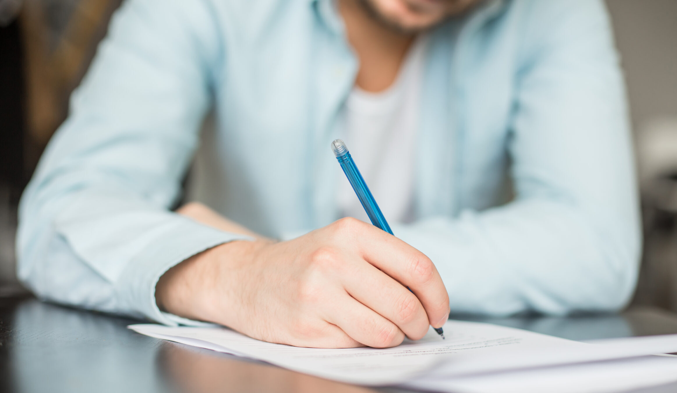 Man,Writing,At,The,Desk